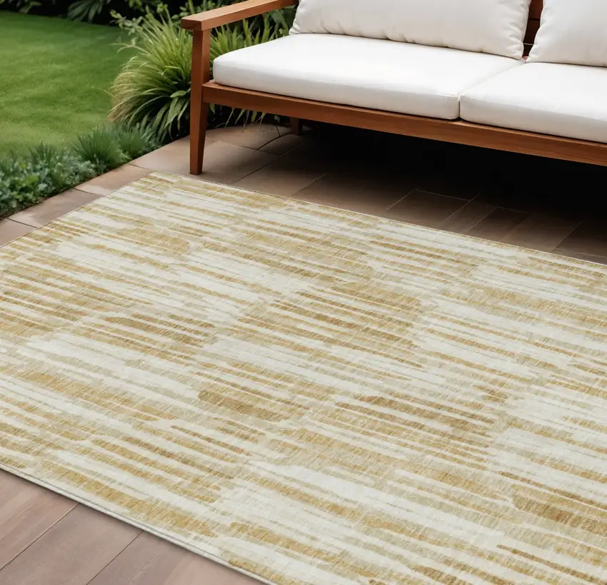 Gold Beige And Ivory Abstract Washable Indoor Outdoor Area Rug Photo 1