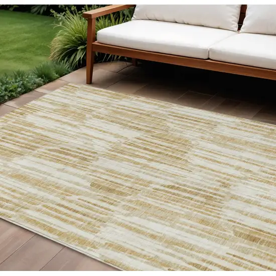 Gold Beige And Ivory Abstract Washable Indoor Outdoor Area Rug Photo 1