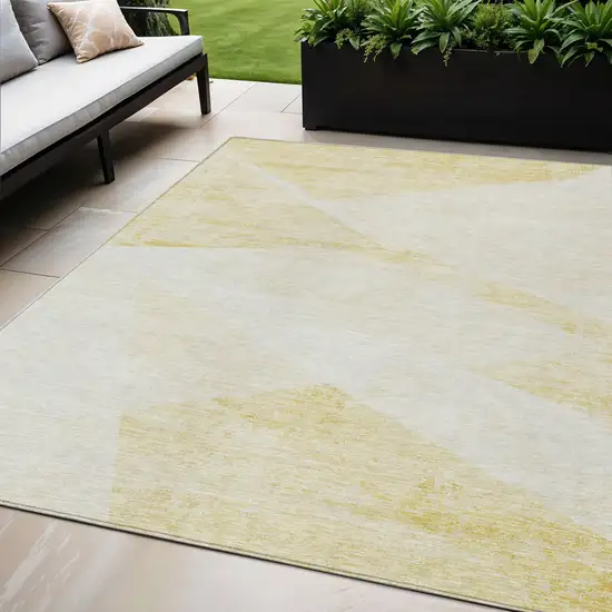 Gold Beige And Ivory Abstract Washable Indoor Outdoor Area Rug Photo 1