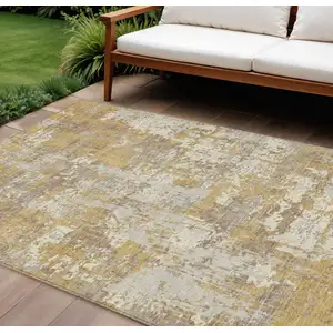 Photo of Gold Brown And Beige Abstract Washable Indoor Outdoor Area Rug
