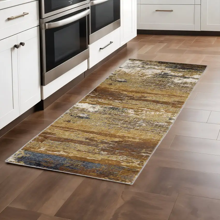 2' X 8' Gold Brown Rust Grey Blue And Beige Abstract Power Loom Stain Resistant Runner Rug Photo 1