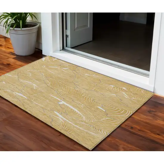 Gold Charcoal And Ivory Abstract Washable Indoor Outdoor Area Rug Photo 1