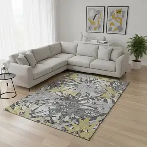 Photo of Gold Gray And Charcoal Abstract Washable Area Rug With UV Protection