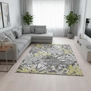 Photo of Gold Gray And Charcoal Abstract Washable Area Rug With UV Protection