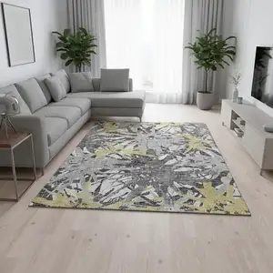 Photo of Gold Gray And Charcoal Abstract Washable Area Rug With UV Protection