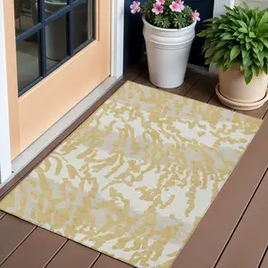 Photo of Gold Gray And Ivory Animal Print Washable Indoor Outdoor Area Rug