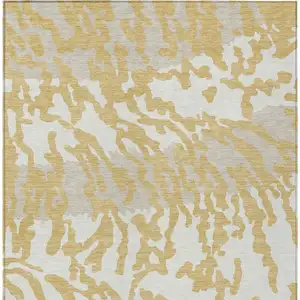 Photo of Gold Gray And Ivory Animal Print Washable Indoor Outdoor Area Rug