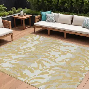 Photo of Gold Gray And Ivory Animal Print Washable Indoor Outdoor Area Rug