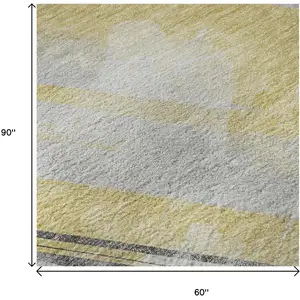 Photo of Gold Gray And Ivory Striped Washable Area Rug With UV Protection