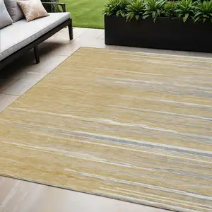 Photo of Gold Gray And Ivory Striped Washable Indoor Outdoor Area Rug
