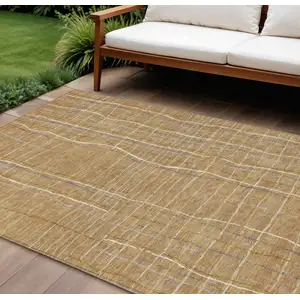 Photo of Gold Gray And Ivory Striped Washable Indoor Outdoor Area Rug