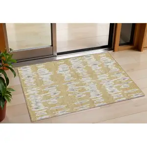 Photo of Gold Gray And Ivory Striped Washable Indoor Outdoor Area Rug