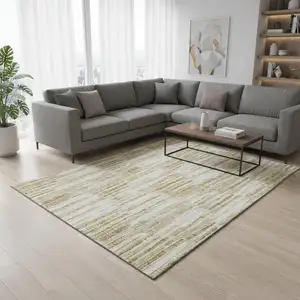 Photo of Gold Ivory And Beige Abstract Washable Area Rug With UV Protection