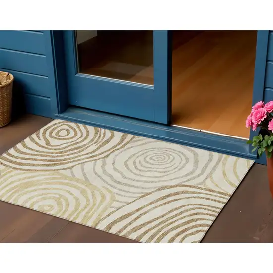 Gold Ivory And Beige Abstract Washable Indoor Outdoor Area Rug Photo 1