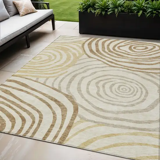 Gold Ivory And Beige Abstract Washable Indoor Outdoor Area Rug Photo 1