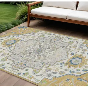 Photo of Gold Ivory And Blue Oriental Washable Indoor Outdoor Area Rug