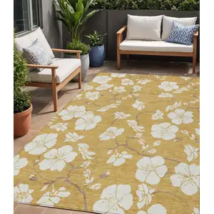 Photo of Gold Ivory And Brown Floral Washable Indoor Outdoor Area Rug