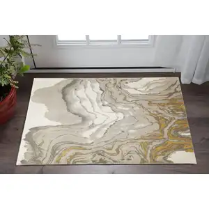 Photo of Gold Ivory And Gray Abstract Stain Resistant Area Rug