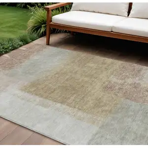 Photo of Gold Ivory And Gray Abstract Washable Indoor Outdoor Area Rug