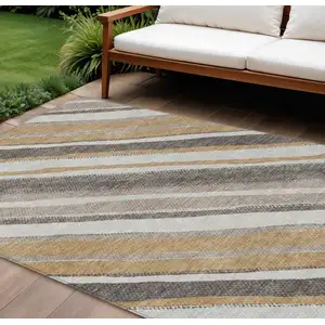 Photo of Gold Ivory And Taupe Striped Washable Indoor Outdoor Area Rug