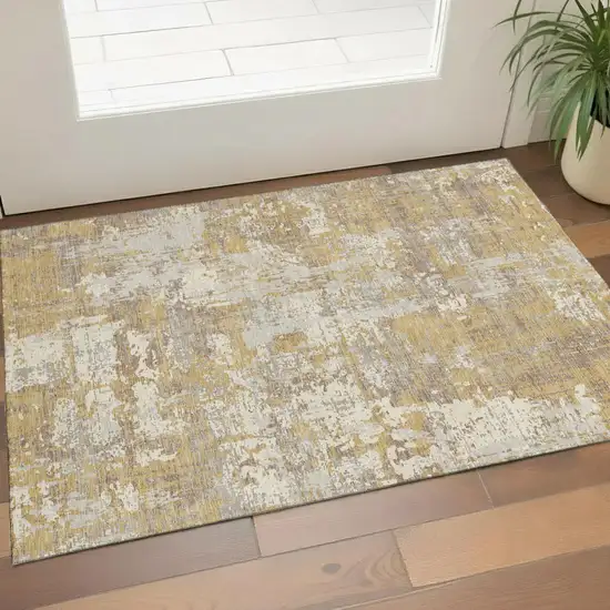 Gold Taupe And Beige Abstract Washable Area Rug With UV Protection Photo 1