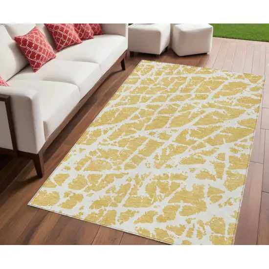 Gold and White Abstract Washable Non Skid Indoor Outdoor Area Rug Photo 1