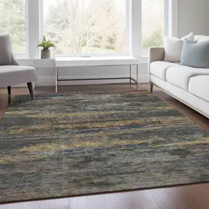 Photo of Graphite Gold And Blue Abstract Washable Area Rug With UV Protection