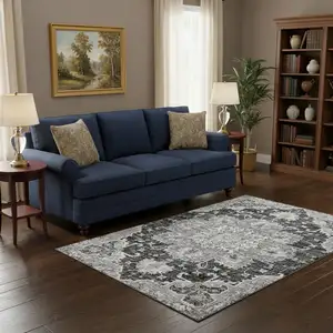 Photo of Graphite Gold And Charcoal Floral Medallion Washable Area Rug With UV Protection