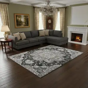 Photo of Graphite Gold And Charcoal Floral Medallion Washable Area Rug With UV Protection