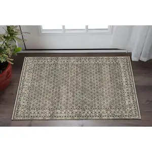 Photo of Gray And Beige Diamond Area Rug With Fringe