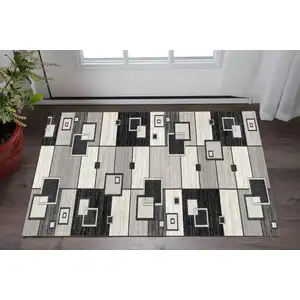 Photo of Gray And Black Geometric Area Rug