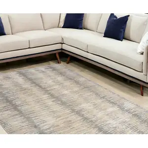 Photo of Gray And Gold Abstract Area Rug With Fringe