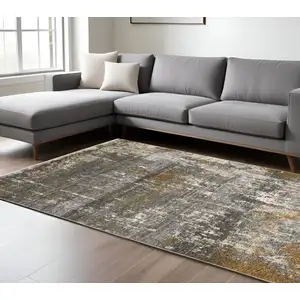 Photo of Gray And Gold Abstract Area Rug With Fringe