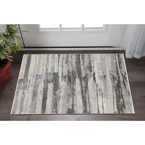 Photo of Gray And Ivory Abstract Area Rug With Fringe