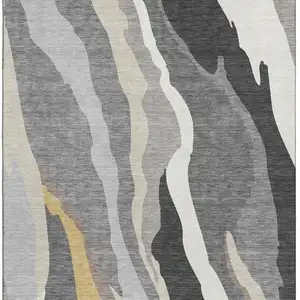 Photo of Gray Gold And Charcoal Abstract Washable Area Rug With UV Protection