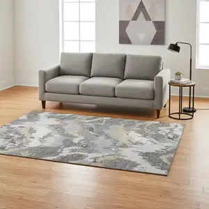 Photo of Gray Gold And Ivory Abstract Washable Area Rug With UV Protection