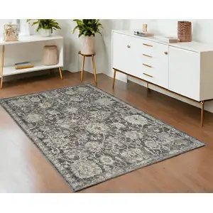 Photo of Gray Ivory And Black Floral Distressed Area Rug