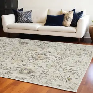 Photo of Gray Ivory And Yellow Floral Distressed Area Rug