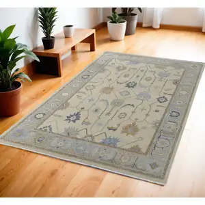 Photo of Gray Ivory and Blue Wool Floral Hand Knotted Area Rug With Fringe