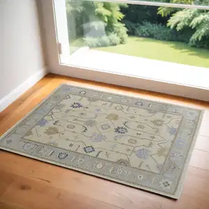 Photo of Gray Ivory and Blue Wool Floral Hand Knotted Area Rug With Fringe