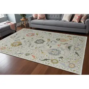 Photo of Gray Ivory and Gold Wool Floral Hand Knotted Area Rug With Fringe