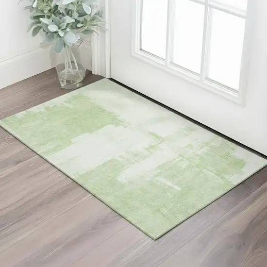 Green And Ivory Abstract Washable Area Rug With UV Protection Photo 1