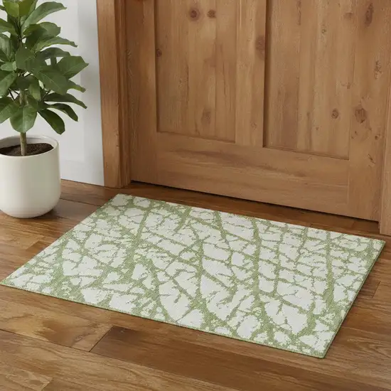 Green And Ivory Abstract Washable Area Rug With UV Protection Photo 1