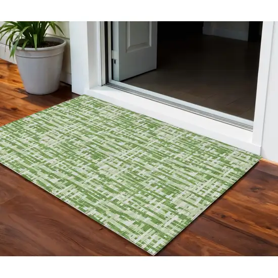 Green And Ivory Abstract Washable Indoor Outdoor Area Rug Photo 1