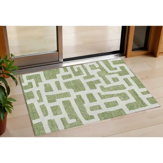 Green And Ivory Abstract Washable Indoor Outdoor Area Rug Photo 1