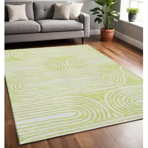 Photo of Green And Ivory Geometric Washable Area Rug With UV Protection