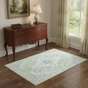 Photo of Green And Ivory Oriental Distressed Washable Area Rug