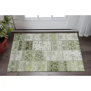 Photo of Green And Ivory Patchwork Washable Area Rug With UV Protection