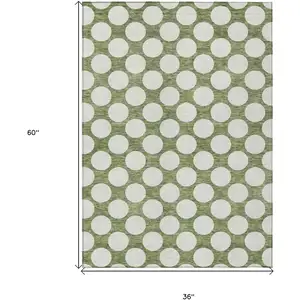 Photo of Green And Ivory Polka Dot Washable Indoor Outdoor Area Rug