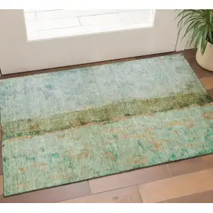 Photo of Green Blue And Gold Abstract Washable Area Rug With UV Protection